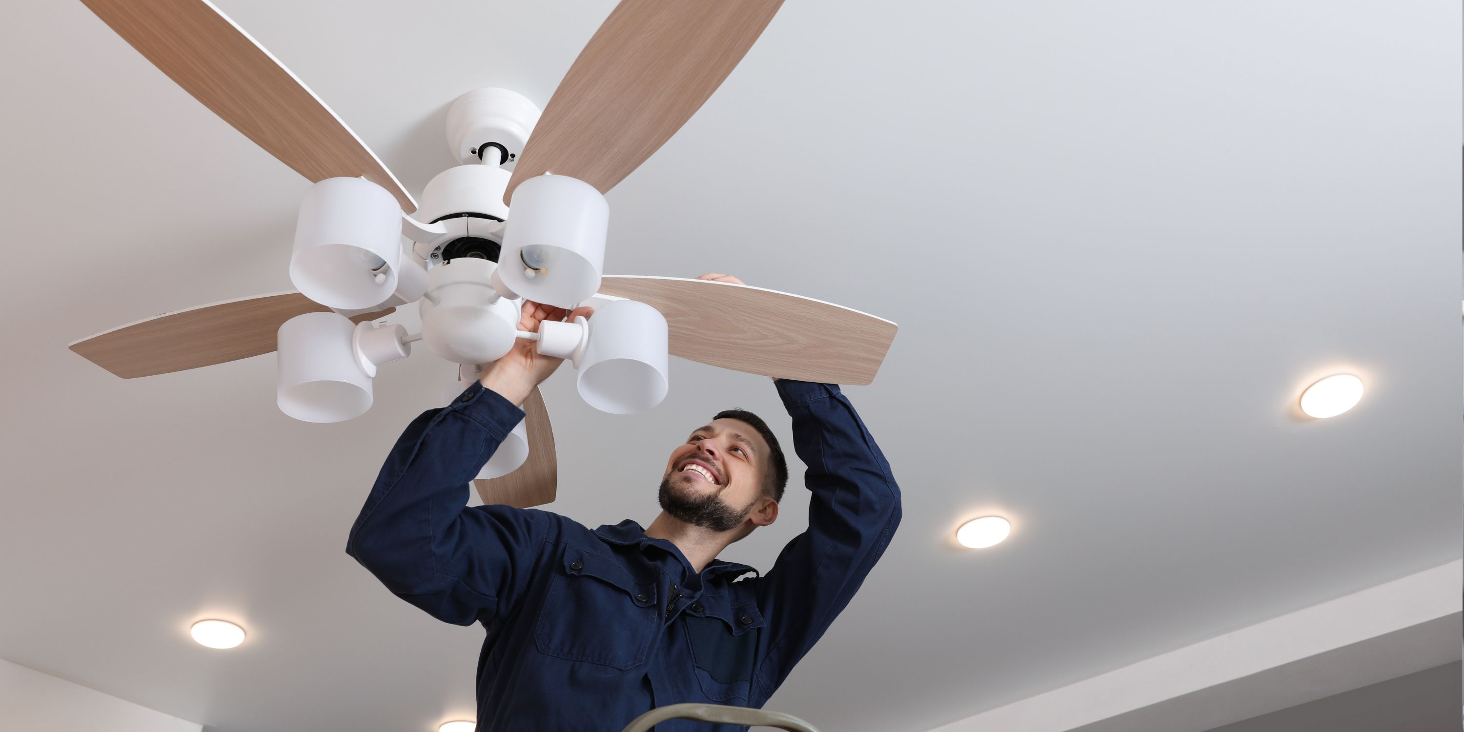 SDG Electric electrician installing a ceiling fan in a Phoenix home